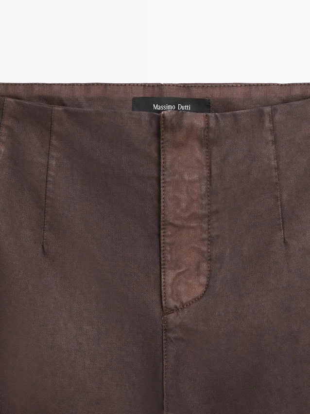 Gewaxt broek met uitlopende pijpen Gewaxt broek met uitlopende pijpen