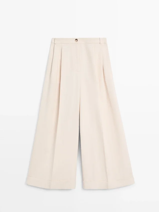 Soepelvallende broeken met omgeslagen zomen Soepelvallende broeken met omgeslagen zomen