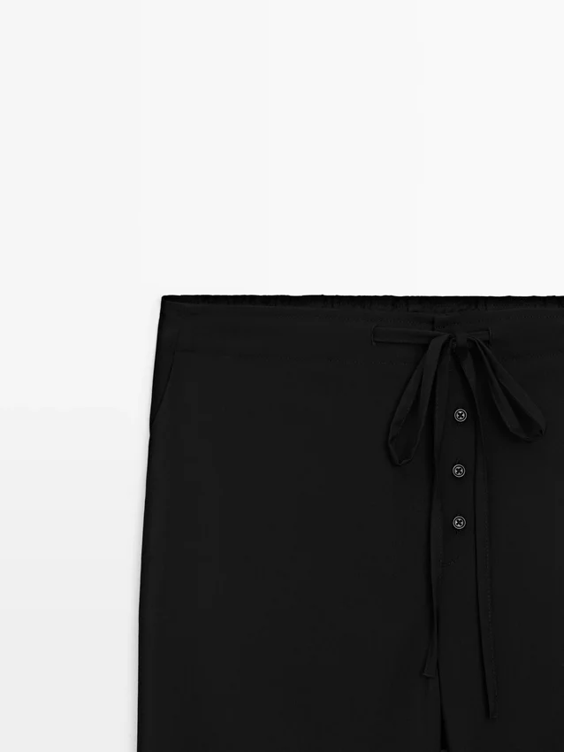 Wollen sarouelbroek met strikdetail Wollen sarouelbroek met strikdetail